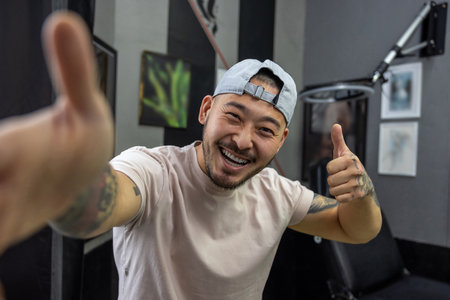 Asian young man in a tattoo salonの写真素材