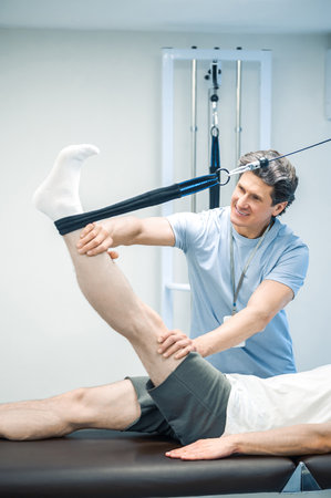 Physal therapist working with patients limb hyperextension