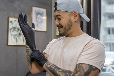 Young asian man putting on glovesの写真素材