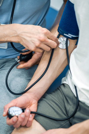 Doctor checking the patients blood presser