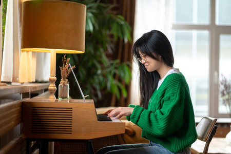 Dark-haired young girl playing the pianoの写真素材