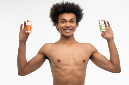African american young man choosing vitamins for his healthcareの写真素材