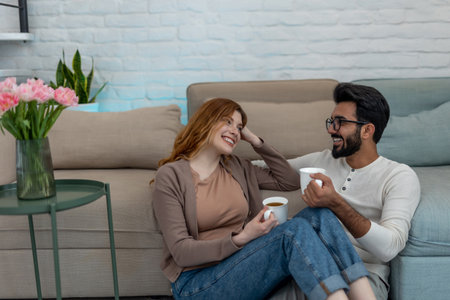 Married couple drinking coffeee, enjoying spending time together, relaxing, sweet tender moment.の写真素材