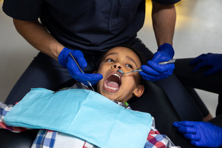 Dark-skinned boy looking scared of medical tools