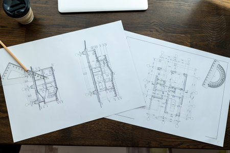Architectural blueprints drawing on worktable, project of house.の写真素材