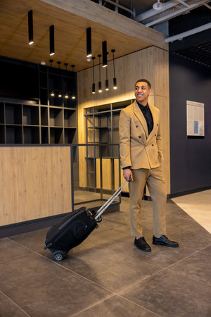 Young well-dressed businessman in a hotel waiting for a room