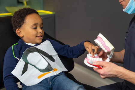 Dark-skinned boy interested in jaw mock-up