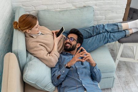 Happy couple spending time at home and looking contentedの写真素材