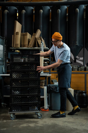 Roasting plant worker uploads coffee beans packs in boxes.の写真素材