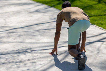 Dark-skinned man getting ready to strat his run