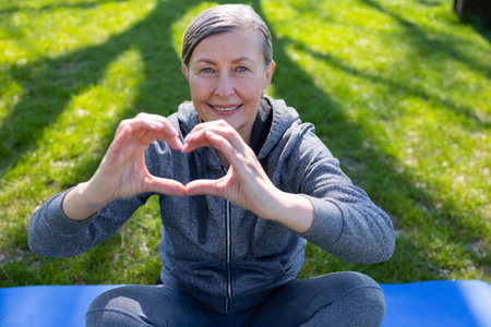 Happy smiling woman showing heart sign
