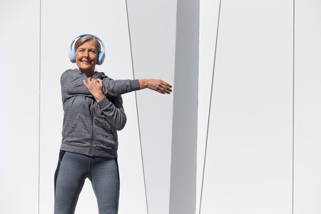 Woman in sportswear exercising and doing exercises for stretchingの写真素材