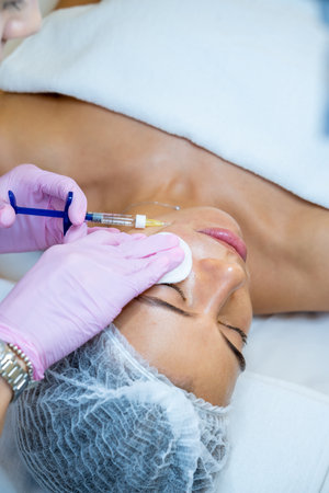 Cosmetology for young female, beautician doctor making injection to face, prp ttherapy.の写真素材