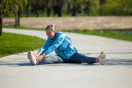 Mature woman exercising and looking involvedの写真素材