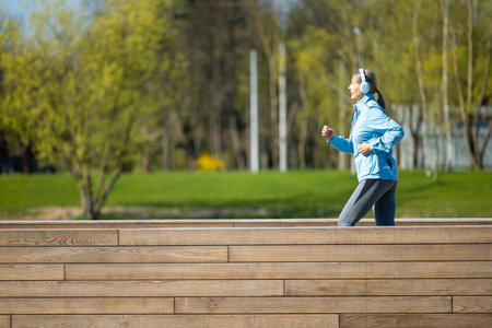 Woman having a morning run in the parkの写真素材