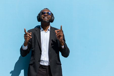 Stylish elegant man in headphones enjoying musicの写真素材
