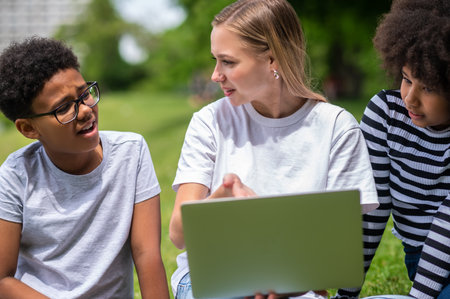 Blonde girl helping teens with their project work
