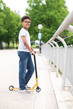 Boy with poses in outdoor park on manual skateboard in casual clothes having fun in open air.の写真素材