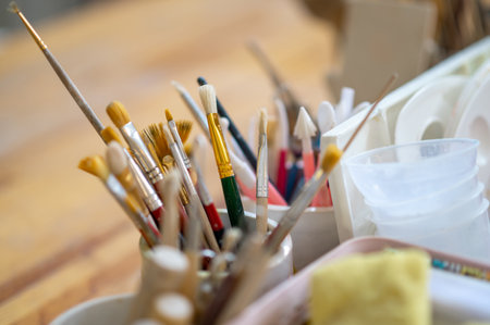 Pottery tools on wooden table in creative studio.の写真素材