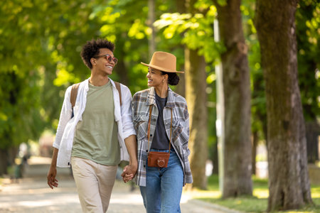 Cute couple spending time together in the park and looking happyの写真素材