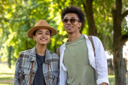 Two young people walking in the park and looking carefreeの写真素材