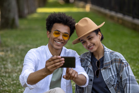 Smiling couple making selfie in the parkの写真素材
