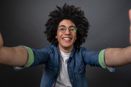 Young guy making selfie and looking excitedの写真素材