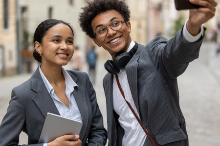 Two business people making selfie together and looking contentedの写真素材