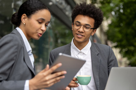 Colleagues having breakfast together and discussing the projectの写真素材