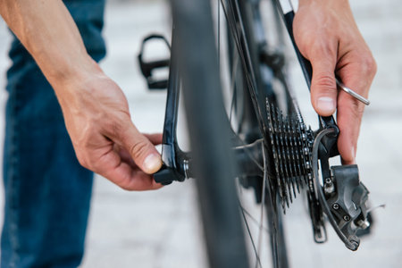 Close up of mans hands fixing a problem with bike tireの写真素材