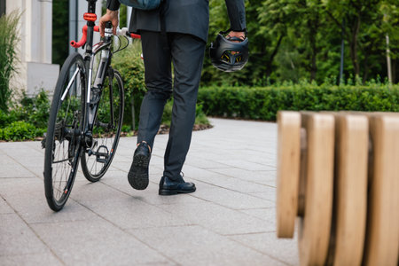 Man in a suit with a bike in the office areaの写真素材