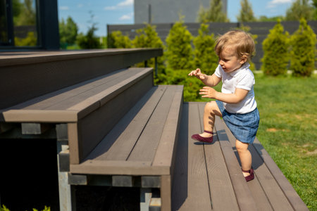 Cute little fair-haired kid on the stepsの写真素材