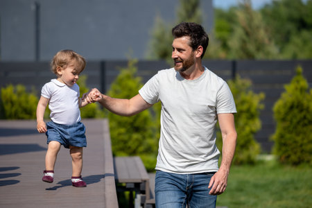 Happy young father and his little son on the walkの写真素材