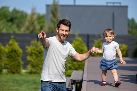 Happy young father and his little son on the walkの写真素材