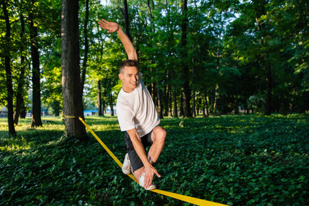 Man in sportswear balancing on the rope
