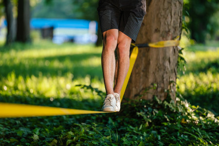 Close up picture of mans legs walking on the ropeの写真素材