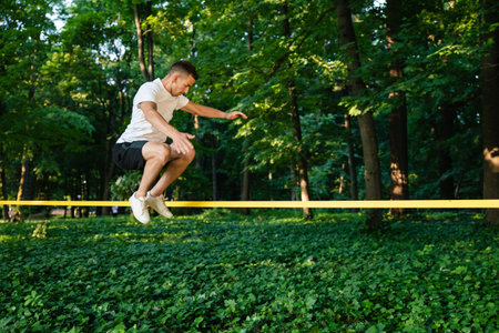 Young man in white tshirt walking on the rope