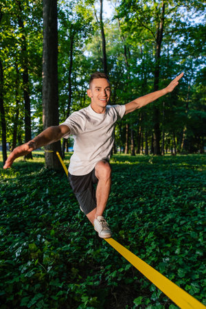 Man in sportswear balancing on the rope