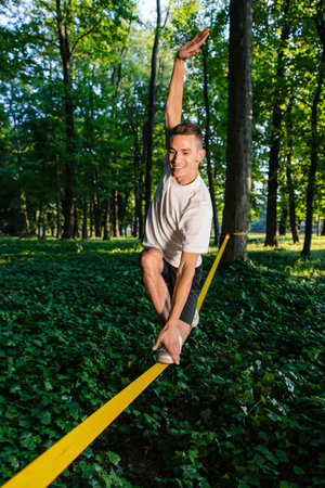 Man in sportswear balancing on the rope
