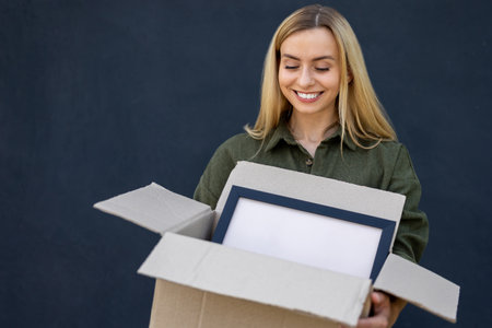 Smiling young woman preparing for relocation