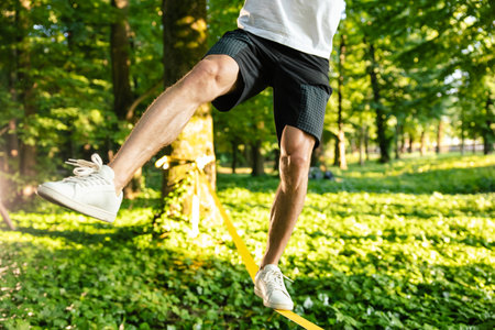 Close up picture of a man balancing on the rope