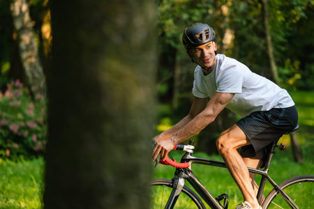 Cyclist on a bike on the road in the parkの写真素材