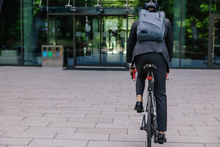 Young businessman commuting to work on eco scooterの写真素材
