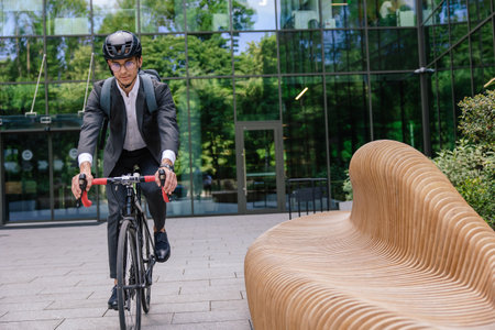 Young businessman commuting to work on eco scooterの写真素材
