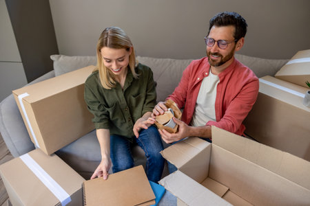 Two people looking busy while packing the boxes for relocation