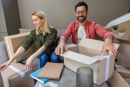 Young family looking involved while packing boxes for the move