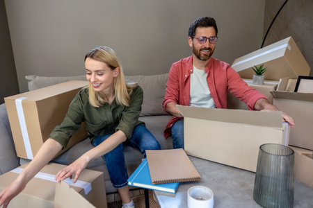 Young family looking involved while packing boxes for the move