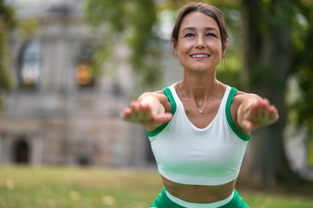 Cute dark-haired woman doing squats and smiling