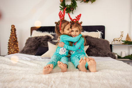 Cute twins hugging each other before sleepの写真素材