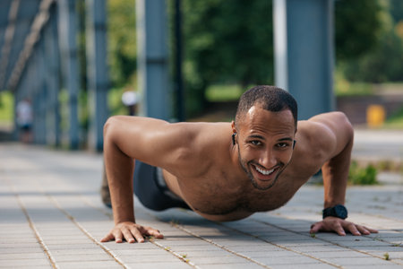 Strong muscular handsome man doing push ups